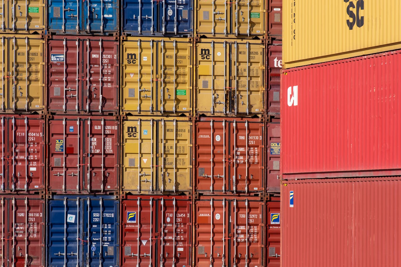 services-03 Colorful shipping containers stacked in a port for transport logistics.
