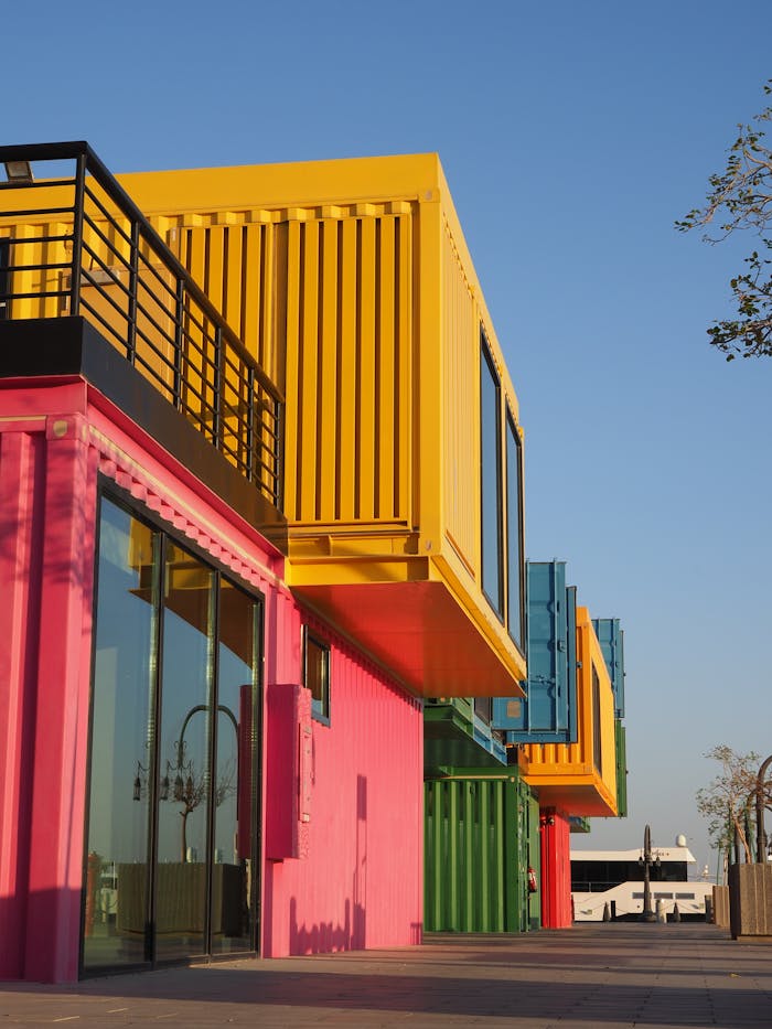 Colorful shipping container-themed building captured on a sunny day in Doha, Qatar.