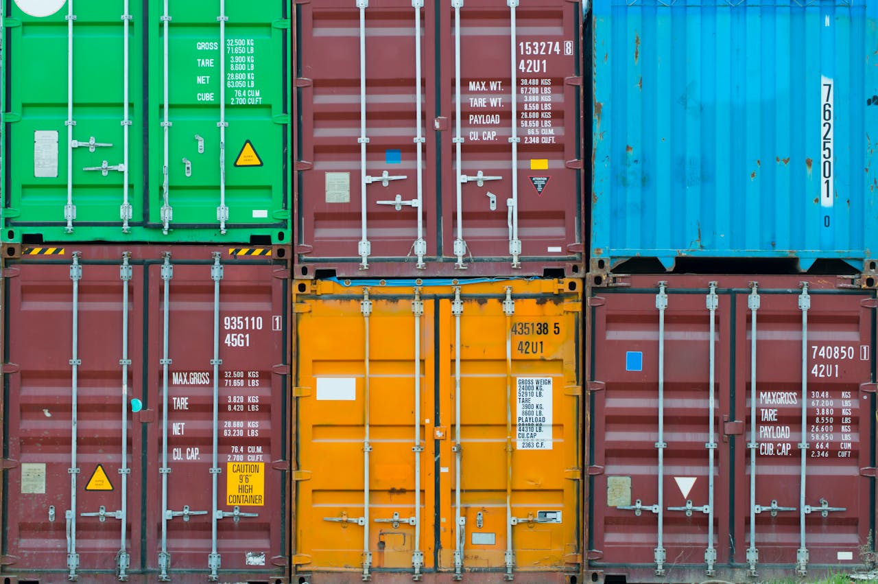 Vividly colored shipping containers stacked together, showcasing global trade and logistics.